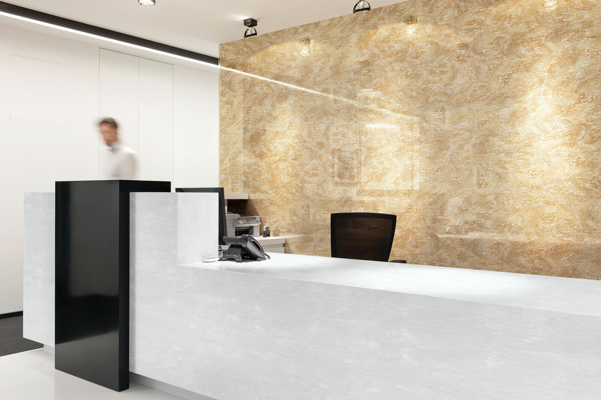 Man walking behind empty reception